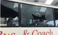  ??  ?? The coach windows smashed by a group throwing stones.