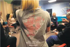  ?? Lea Suzuki / The Chronicle ?? Above: Lani Jalliff, whose Coffey Park home was not destroyed, wears a Coffey Strong T-shirt from the Standing Homes support group she started for other residents who did not lose their homes but are left with guilt and huge cleanup bills.