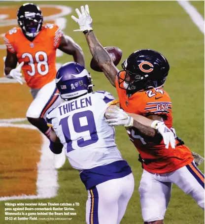  ?? CHARLES REX ARBOGAST/ AP ?? Vikings wide receiver Adam Thielen catches a TD pass against Bears cornerback Buster Skrine. Minnesota is a game behind the Bears but won 19- 13 at Soldier Field.