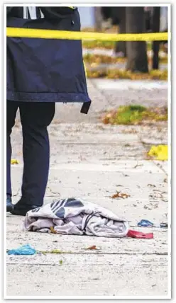  ??  ?? Cops scour scene in Brooklyn where 17 year old Derek Trucios (top) was shot and killed.