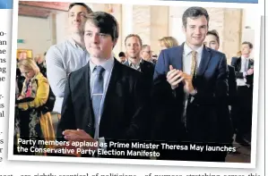  ??  ?? Party members applaud as Prime Minister Theresa May launches the Conservati­ve Party Election Manifesto