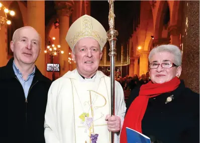  ?? PHOTO: FRANK MCGRATH ?? Proud:New Bishop of Clogher Larry Duffy with brother Peter and sister Anna. Below, Dr Eamon Martin performs the ordination.