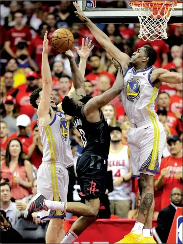  ?? AP/David Phillip ?? Rockets guard James Harden (center) is fouled by Warriors guard Klay Thompson (left) as he tries to score past forward Kevon Looney on Monday during Game 7 of the Western Conference finals in Houston.