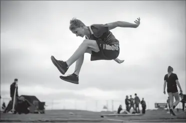  ?? Herald photo by Tijana Martin ?? Jed Magarrell from Coaldale R.I. Baker School competes in the midget long jump during the County of Lethbridge Junior High Track Meet at the University of Lethbridge Community Stadium on Thursday.