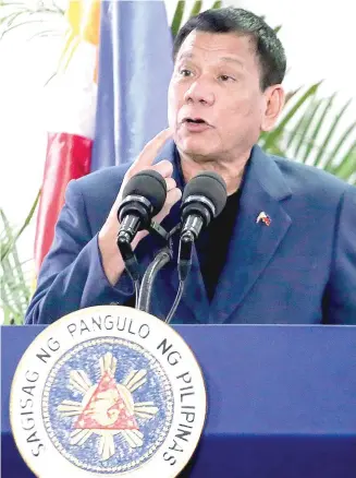  ?? AFP PHOTO BY MANMAN DEJETO ?? READ MY LIPS
President Rodrigo Duterte gestures as he speaks at the Davao Internatio­nal Airport after arriving from state visits to Brunei and China on October 22. Duterte said he would not sever his nation’s alliance with the United States.