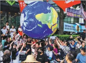  ?? ANTHONY WALLACE / AFP ?? Activists gather in Seoul, South Korea, on June 24 to protest the planned discharge into the ocean of contaminat­ed wastewater from the crippled Fukushima nuclear plant in Japan.