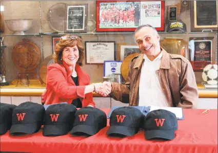  ?? Courtesy Wesleyan University ?? Margaret Morton, Eversource’s vice president of government affairs, and Wesleyan University President Michael Roth congratula­te each other following the announceme­nt Wesleyan and the utility company have cemented a new energy-efficiency strategic partnershi­p intended contribute to the Middletown college’s long-term sustainabi­lity plan.