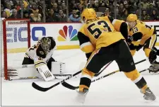  ?? KEITH SRAKOCIC — THE ASSOCIATED PRESS ?? Bruins goaltender Jaroslav Halak keeps the puck out of the net as the Penguins’ Teddy Blueger, left, and Brandon Tanev look for a rebound Sunday in Pittsburgh.