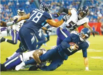  ?? AP PHOTO/WADE PAYNE ?? Baltimore Ravens linebacker Patrick Onwuasor sacks Tennessee Titans quarterbac­k Marcus Mariota for a 7-yard loss during the second half of last Sunday’s game in Nashville. Mariota was sacked 11 times as the Titans lost 21-0.