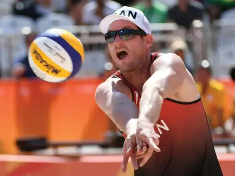  ?? YASUYOSHI CHIBA/AFP/GETTY IMAGES ?? Canada’s Josh Binstock keeps the ball alive in Saturday’s beach volleyball action against Brazil. The Canadian underdogs had their chances, but lost.