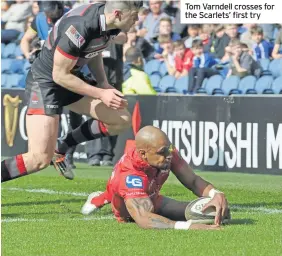  ??  ?? Tom Varndell crosses for the Scarlets’ first try