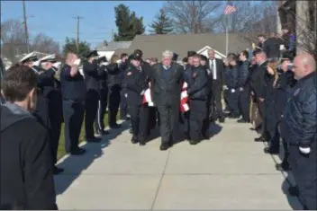  ?? PETE BANNAN - DIGITAL FIRST MEDIA ?? Brookhaven Fire Company members carry the casket of former Chief Robert Montella Sr. out of Our Lady of Charity Church Friday following his funeral mass. Montella was a life time active member of the Brookhaven Fire Co. Station 52. He held numerous positions in the company including Foreman, Captain, Assistant Chief and Chief. He was also an Asst. Chief at Briarcliff­e Fire Company.