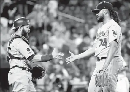  ?? Will Newton Getty Images ?? THE DODGERS’ Kenley Jansen celebrates with catcher Russell Martin after retiring the Orioles in order for a save Thursday night.