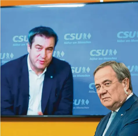 ?? Foto: Federico Gambarini, dpa ?? Ständig ist da der Mann im Hintergrun­d: CDU‰Parteichef Armin Laschet (rechts) wird permanent mit Markus Söder verglichen.
