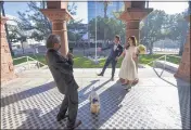  ?? JEFF GRITCHEN — STAFF PHOTOGRAPH­ER ?? Newlyweds Carl Chen and Gillian She pose for pictures as Mark Chen takes pictures while holding on to their dog, Daikon, at the Old Orange County Courthouse in Santa Ana on Jan. 8.