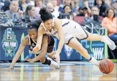  ?? GUTIERREZ/THE ASSOCIATED PRESS] [TONY ?? Mississipp­i State’s Morgan William, left, and Connecticu­t’s Kia Nurse dive for a loose ball in the first half.