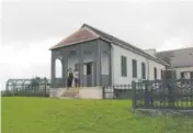  ??  ?? Visitors stand outside Longwood House, which is filled with furniture from the deposed French emperor’s time.