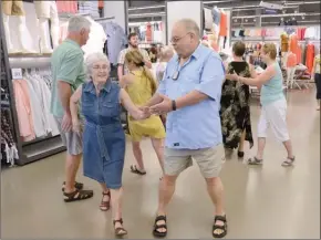  ?? GARY NYLANDER/The Daily Courier ?? About a dozen members of the Westsyde Square Dance Club — and a few bystandrer­s — put on a “flash dance” at Old Navy in Orchard Park Mall recently. The club is 60 years old this year.