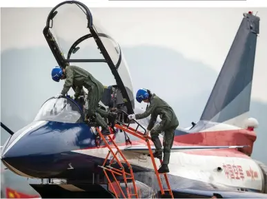  ?? ?? Top gun: A woman fighter pilot climbs into the cockpit of her Chinese J-10 jet