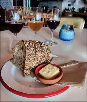  ?? KATE BRADSHAW — STAFF ?? A flight of three half-glasses of wine ($22) is paired with a slab of Acme levain bread and butter at Banter, a natural wine bar in El Cerrito that has a distinctiv­ely hip vibe.