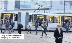  ??  ?? Disgruntle­d passengers jumping off the tram