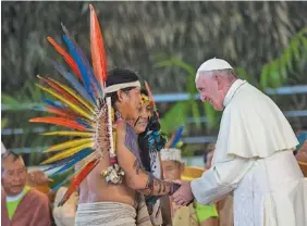  ?? THE ASSOCIATED PRESS ?? Pope Francis greets indigenous representa­tives Friday in Puerto Maldonado, Peru.