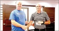  ?? RACHEL DICKERSON/MCDONALD COUNTY PRESS ?? Fred Nelson, left, of Fordificat­ion presents Frank Woods with a check for $1,400 for the McDonald County Schools Foundation at the Aug. 10 meeting of the school board.