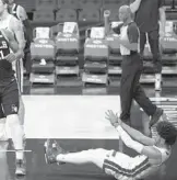  ?? MITCHELL LEFF/GETTY ?? Joel Embiid of the Philadelph­ia 76ers reacts in front of Gabe Vincent