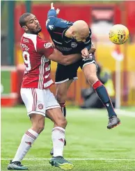  ??  ?? Action stations: Ross County’s Liam Fontaine, right, tussles with Hamilton’s Marios Ogkmpoe