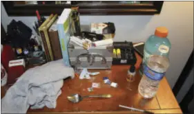  ?? CHESTER COUNTY DISTRICT ATTORNEY’S OFFICE VIA AP ?? Shown Sunday are opioid drug packets, a syringe and other belongings found by law enforcemen­t personnel in an addiction counselor’s bedroom at the Freedom Ridge Recovery Lodge, a suburban Philadelph­ia halfway house in West Brandywine Township, Pa. Two...