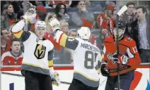  ?? Alex Brandon ?? The Associated Press Knights right wing Reilly Smith, left, and center Jonathan Marchessau­lt celebrate Smith’s goal in the third period Sunday in Washington. Nearby, is Capitals left wing Jakub Vrana.