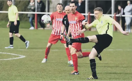  ??  ?? Darren Richardson clears for Bishop Auckland in Saturday’s 3-1 defeat at Ryhope CW under pressure from Chris Trewick. Pics by Kevin Brady.