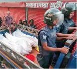  ?? — AP ?? Bodies of militants killed by the police after the raid near Dhaka on Saturday