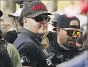  ?? Jacquelyn Martin Associated Press ?? THE INITIALS, seen here at a Trump event in 2020, recall violent paramilita­ry groups in Latin America.