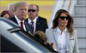  ?? THE ASSOCIATED PRESS ?? U.S. President Donald Trump, left, and his wife Melania arrive at the airport in Helsinki, Finland on Sunday, on the eve of his meeting with Russian President Vladimir Putin.