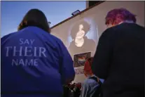  ?? NATE BILLINGS — THE OKLAHOMAN VIA AP ?? A photograph of Nex Benedict, a nonbinary teenager who died one day after a fight in a high school bathroom, is projected during a candleligh­t service at Point A Gallery, Saturday, Feb. 24, 2024, in Oklahoma City.