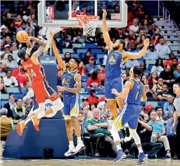  ?? — AP ?? New Orleans Pelicans’ Brandon Ingram (from left) shoots against Jacob Evans and Omari Spellman of the Golden State Warriors in the first-half of their NBA game in New Orleans on Monday. Golden State Warriors won 120-92.