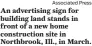  ?? Associated Press ?? An advertisin­g sign for building land stands in front of a new home constructi­on site in Northbrook, Ill., in March.