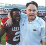  ?? (Arkansas Democrat-Gazette file photo) ?? Razorbacks Coach Houston Nutt and cornerback Chris Houston walk off the field after the game.