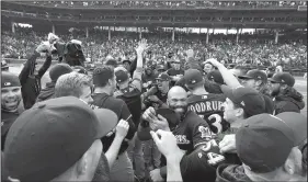  ?? AP/MATT MARTON ?? Members of the Milwaukee Brewers celebrate after beating the Chicago Cubs 3-1 to win the National League Central Division title Monday. The Brewers will face the winner of today’s National League wild-card game between the Cubs and the Colorado Rockies on Thursday.