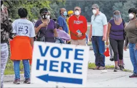  ?? Ben Gray The Associated Press ?? People wait to vote in Decatur, Ga. More than 22 million Americans have already voted.