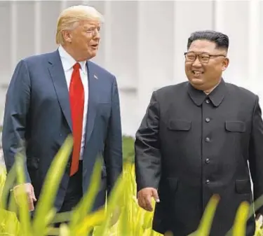  ?? AP ?? President Trump walks with North Korean leader Kim Jong Un at their Singapore summit Tuesday.