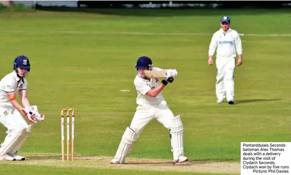  ??  ?? Pontarddul­ais Seconds batsman Alex Thomas deals with a delivery during the visit of Clydach Seconds. Clydach won by five runs
Picture: Phil Davies