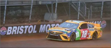  ?? (AP/Bristol Herald Courier/David Crigger) ?? Kyle Busch drives Friday on the newly-installed dirt track at Bristol Motor Speedway in Bristol, Tenn. The NASCAR Cup Series is slated to have its first dirt race since 1970 today, but the dirt, the track’s 28-degree banking and 3,400-pound cars appear to be a terrible fit.