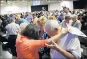  ?? Vernon Bryant Dallas Morning News ?? ATTENDEES pray in groups this week at the Southern Baptist Convention’s annual meeting in Dallas.