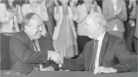  ??  ?? May 30, 2017: Andrew Weaver and John Horgan shake hands after signing their agreement at the legislatur­e.