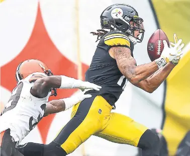  ?? JOE SARGENT GETTY IMAGES ?? Steelers receiver Chase Claypool wrote “UKO” on his wrist tape in memory of a former teammate. The tattoo on his right arm honours his older sister, who died by suicide.