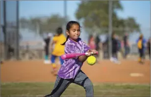  ??  ?? Kiana Alvarez, 9, attempts to hit the ball during a hitting drill in Imperial Valley College’s second annual all-skills softball camp. VINCENT OSUNA PHOTO