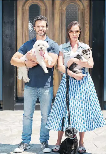  ?? BELL MEDIA/THE CANADIAN PRESS ?? Rob Scheinberg and Danielle Eden-scheinberg appear in the new 10-episode docu-series, Dog Tales Rescue, which focuses on their work on behalf of abused and abandoned animals and the rural Ontario property they’ve opened up to house them.