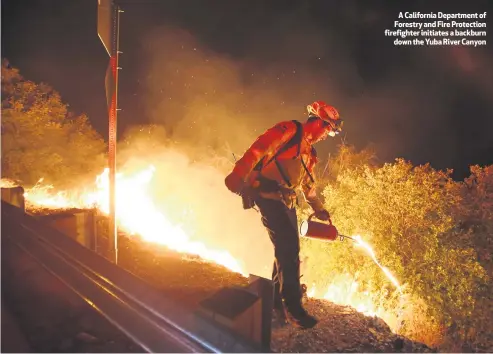  ??  ?? A California Department of Forestry and Fire Protection firefighte­r initiates a backburn
down the Yuba River Canyon